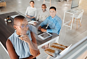 Group of diverse businesspeople having a meeting in an office at work. Young focused african american businesswoman