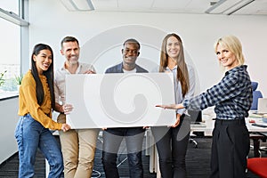 Group of diverse casual business people standing in office holding banner
