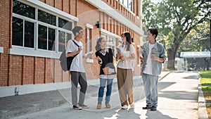 Group of diverse cheerful Asian students friends are enjoying talking while walking in their campus