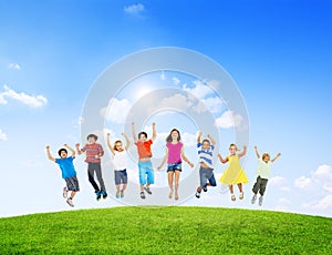 Group of Diverse Children Jumping Outdoors