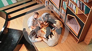 Group of diverse children sitting in a circle while reading a book. Edification