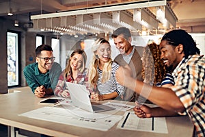 Group of diverse designers, business people brainstorming on meeting in office