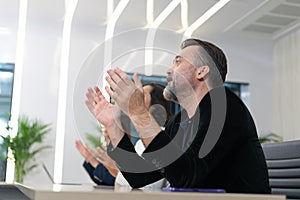 Group of diverse employees business people team during a brainstorming meeting. Multiracial coworkers showing hand clapping