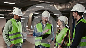 Group of Diverse Engineer Workers Engaged in Technical Discussions on Work Processes at the Logistic Centre. Male Boss