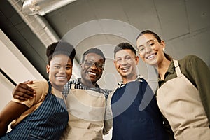 Group of diverse fashion designers hugging. Portrait of happy businesspeople together. Tailors relaxing in their design