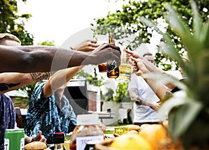 Group of diverse friends celebrating drinking beers together summer time