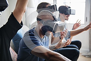 Group of diverse friends experiencing virtual reality with VR hea