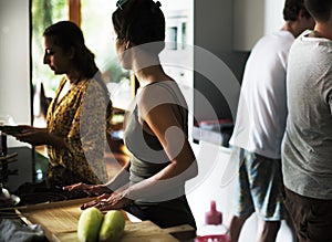 Group of diverse friends preparing barbecue in the kitchen together