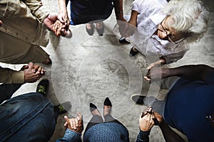 Group of diverse hands holding each other support together teamwork aerial view