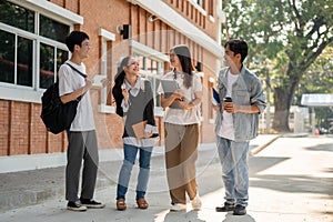 Group of diverse happy Asian college students are enjoying talking after classes on a footpath