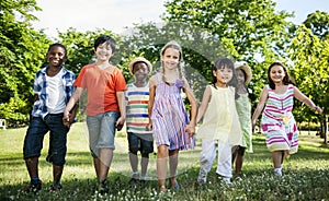 Group of diverse kids having fun together in the park photo