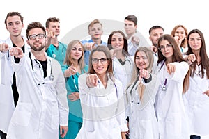 Group of diverse medical professionals pointing at you