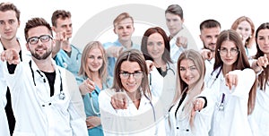 Group of diverse medical professionals pointing at you