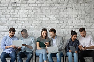 Group of diverse multiethnic young people sharing information using wifi