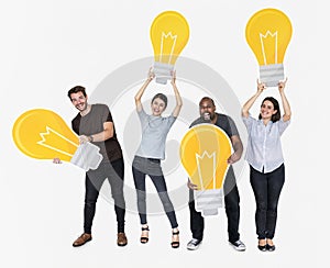 Group of diverse people with bright yellow light bulbs