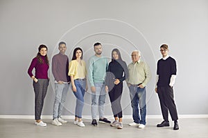 Group of diverse people in casual clothes standing together and looking at camera