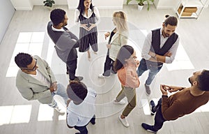 Group of diverse people communicating at business event or psychological training