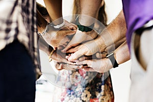 Group of diverse people joined hands together teamwork