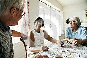 Group of diverse senior people using mobile phone photo