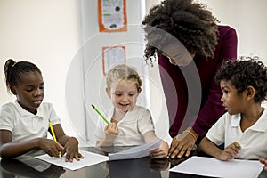 Group of diverse students drawing in art class