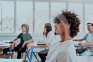 A group of diverse students engages in lively discussion as they educate themselves in a modern classroom, embracing the