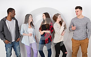 Group of diverse students standing in line indoors