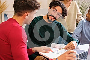 Group of diverse university colleagues studying together at shared flat.