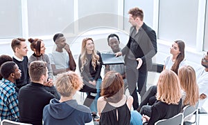 group of diverse young people listening to the report of their coach