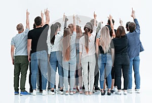 Group of diverse young people pointing at blank screen.