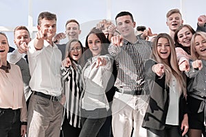 Group of diverse young people pointing at the camera