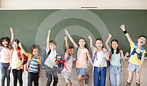 Group of diverse young students standing together in classroom