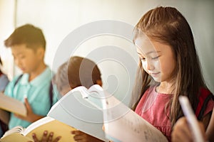 diverse young students studying in  classroom