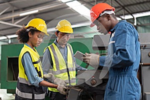 group of diversity African American industrial Engineer manager woman discussion with asian repair man mechanic worker man using