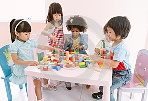 Group of diversity kids playing with colorful blocks on table in class at the kindergarten.Kindergarten international school,