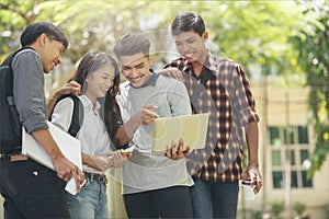 Group of Diversity Student working on laptop together at university, Happy multi ethnic friend successfully completes the thesis