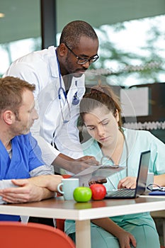 group doctors in cafeteria relaxing