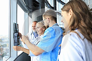 Group of doctors checking x-rays in a hospital