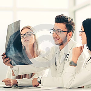 Group of doctors discuss the patient`s x-ray
