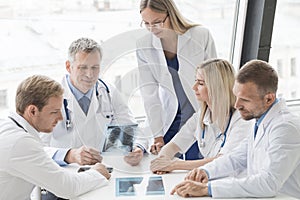 Group of doctors discuss x-ray