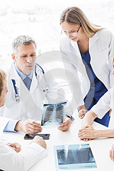 Group of doctors discuss x-ray