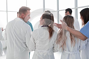 Group of doctors discussing something standing in the hospital lobby