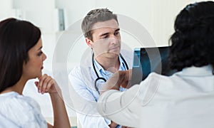 A group of doctors examining an x-ray