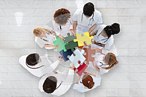 Group Of Doctors Holding Colorful Puzzle