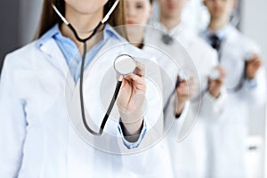 Group of doctors holding stethoscope head close-up. Physicians ready to examine and help patient. Medicine concept