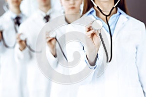 Group of doctors holding stethoscope head close-up. Physicians ready to examine and help patient. Medicine concept