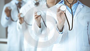 Group of doctors holding stethoscope head close-up. Physicians ready to examine and help patient. Medicine concept