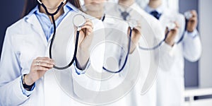 Group of doctors holding stethoscope head close-up. Physicians ready to examine and help patient. Medicine concept