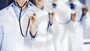 Group of doctors holding stethoscope head close-up. Physicians ready to examine and help patient. Medicine concept