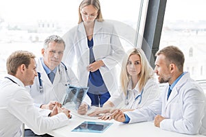 Group of doctors looking at x-ray