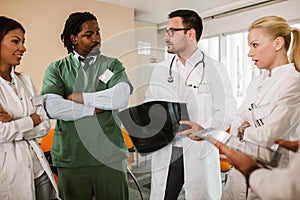 Group of doctors and nurses in meeting cooperating to make diagnose